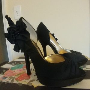 Black satin heels with flower detail